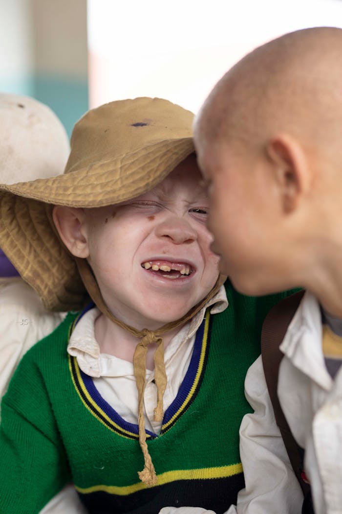 Portrait of two children sharing a playful moment in Tanga, Tanzania.